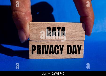 Data privacy day message written on wooden blocks with blue background. Conceptual data privacy day symbol. Copy space. Stock Photo