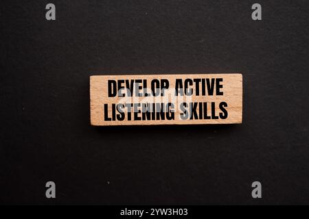 Develop active listening skills message written on ripped torn yellow ...