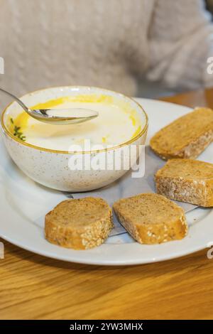 Creamy soup in a bowl with several slices of bread on a plate, autumn creations, Cafe Kuh, Deckenpfronn, Black Forest, Germany, Europe Stock Photo