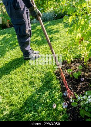 Hoeing flower beds Stock Photo