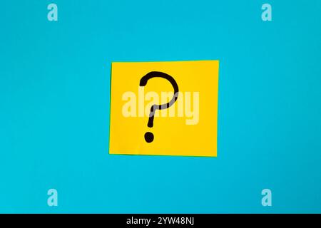 Yellow paper with question mark on blue background, question concept Stock Photo