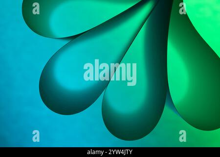 Folded paper illuminated by green coloured lights to create a dramatic, abstract look Stock Photo