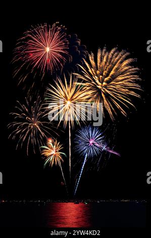 Composite of Fireworks Against Black with Shoreline and Reflections - 68-74 Stock Photo