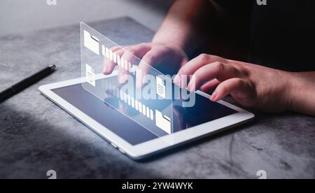Woman use digital tablet with data transfer VR interface. Transfer file of data between folders. Backup information. DMS, document management system. Stock Photo