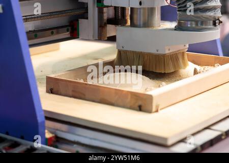 Close up of CNC router machine carving wood. Selective focus. Stock Photo