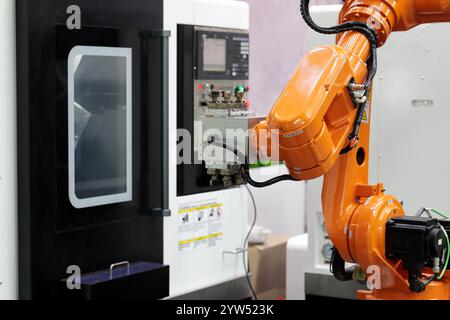 Collaborative robot and CNC machining center. Automated robotic workcell. Selective focus. Stock Photo