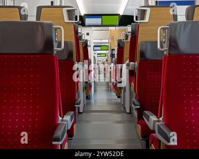 The inside of a modern passenger train is shown, with no riders currently onboard. Stock Photo