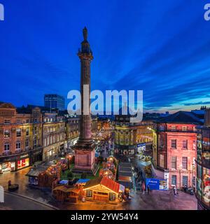 View at dusk at Christmas time looking across Grey's Monument in Newcastle upon Tyne towards the christmas market with christmas lights Stock Photo