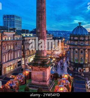 View at dusk at Christmas time looking across Grey's Monument in Newcastle upon Tyne towards the christmas market with christmas lights Stock Photo