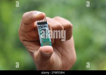 Bluetooth module used for wireless communication used in making robotics project held in the hand Stock Photo