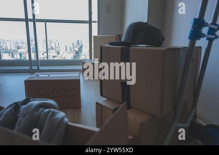 A room full of boxes with the word Clothes on them. New home concept. Stock Photo