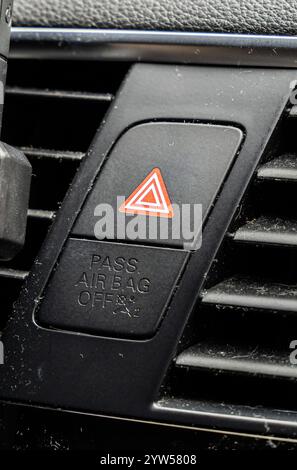 Close up of the Hazard light button feature in the shape of a red triangle, in the interior of a car. Stock Photo