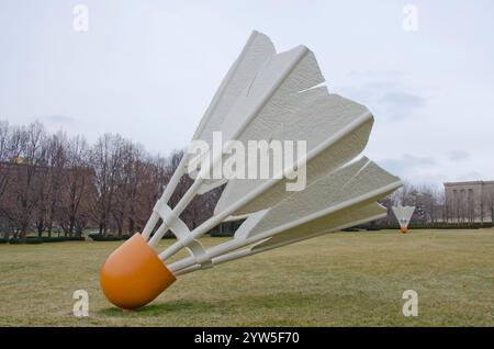 One of four giant shuttlecocks on the grounds of the Nelson Adkins Museum of Art overlook the Kansas City, Missouri skyline. Stock Photo