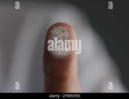 Man pressing finger to surface showing friction ridges pattern, closeup. Scanning fingerprint Stock Photo