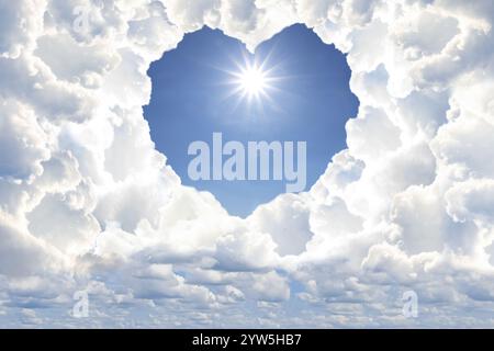 Bright light shining in sky through heart shaped gap in clouds. Love of God, concept Stock Photo