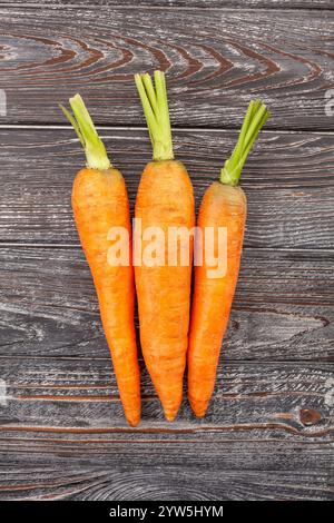 carrots group on wood background top view Stock Photo