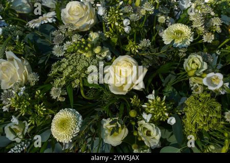 Elegant Arrangement of White Roses With Greenery and Florals. Stock Photo