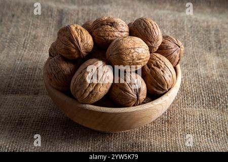A bowl full of shelled walnuts on burlap sack,top view Stock Photo