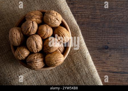 A bowl full of shelled walnuts on burlap sack,top view Stock Photo