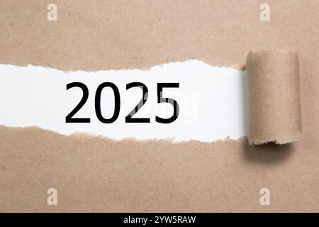 2025 on Torn Paper. New year concept with typographic 2025 on paper Stock Photo