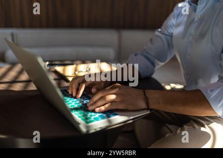 Unrecognizable man using laptop while working in office Stock Photo