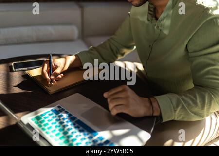Unrecognizable man using laptop while working in office Stock Photo
