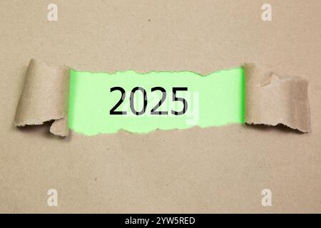 2025 on Torn Paper. New year concept with typographic 2025 on paper Stock Photo