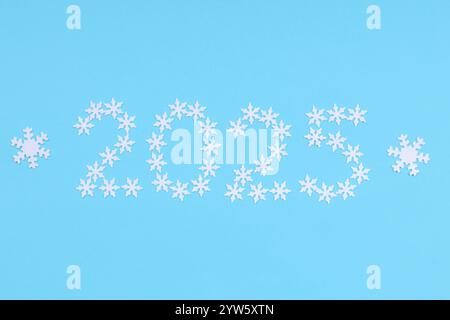 Number 2025 made of confetti in the shape of snowflakes symbolize New Year Stock Photo
