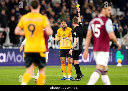 Wolverhampton Wanderers' Matheus Cunha is shown a yellow card by referee John Brooks during the Premier League match at the London Stadium, London. Picture date: Monday December 9, 2024. Stock Photo