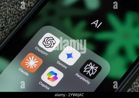 ChatGPT, Gemini, Microsoft Copilot, Claude, and Perplexity app icons are seen on the screen of an iPhone. Generative AI competition concepts. Stock Photo