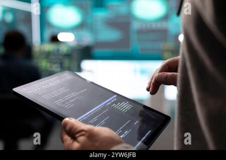 Governmental hackers analyzing big data for cyber threat detection, working at agency desks. Professional expert woman analyzes cyber intelligence and prevention of digital threats. Stock Photo