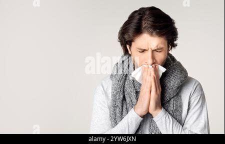 Guy with scarf around his neck, feels sick Stock Photo