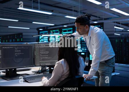System administrators in data center running system diagnostic tests on PC to fix problems. IT experts deploying and error checking utilities on computers to repair network issues in server rigs Stock Photo