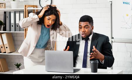 Anxious African American colleagues finding mistake in project or missing deadline at workplace Stock Photo