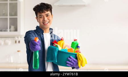 Handsome asian guy showing his cleaning tools Stock Photo