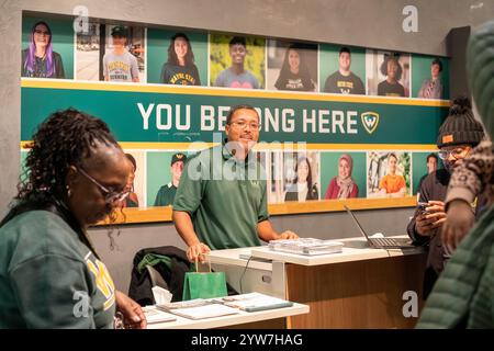Detroit, Michigan - At Wayne State University on Noel Night, a recruiter talks to potential students. The annual Noel Night at the start of the holida Stock Photo