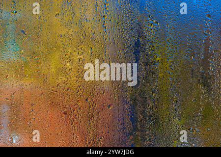 colored background of water droplets. condensation on the glass Stock Photo