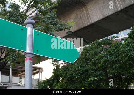 Blank right pointer directional arrows signpost on the side of the road.  green sign mock up template. Stock Photo