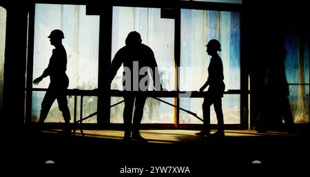 Silhouette, workers and architect with blueprint on site for building inspection, property development and compliance. Construction, contractor and Stock Photo