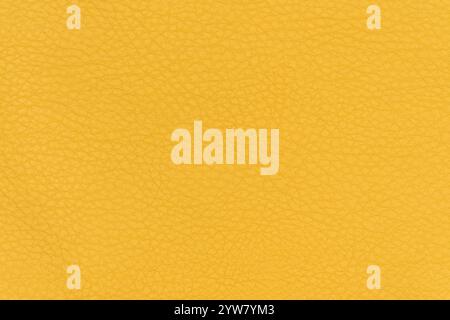 Yellow color abstract synthetic leather pattern for background. Close-up table top view photography of yellowish colour surface artificial leather Stock Photo