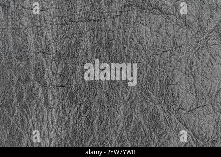 Abstract dark gray color artificial leather pattern for background. Close-up photo of shadow light black color surface level imitation leather materia Stock Photo