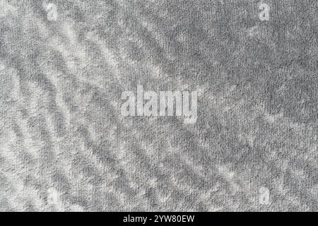 Gray color velvet or velour with short pile fluffy and soft texture background. Closeup detail macro photography top view of grey colour surface fabri Stock Photo