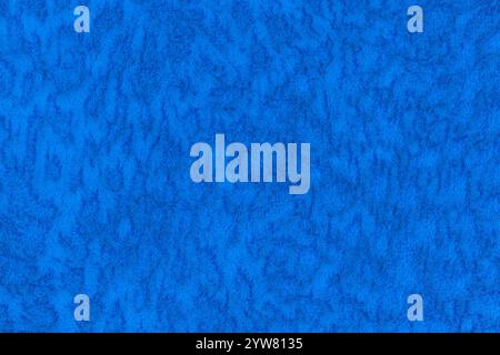 Blue color velour or velvet with short pile fluffy and soft texture background. Close-up image of lapis colour surface level fabric material, azure co Stock Photo
