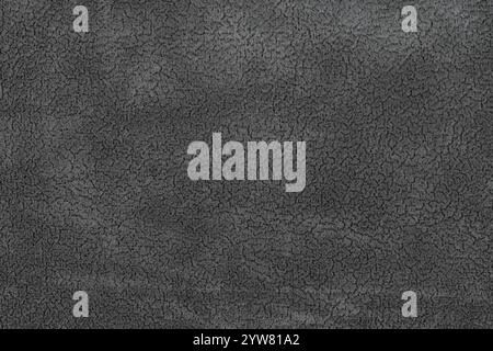 Black color fabric cloth with short pile fluffy and soft abstract texture background. Close-up photography of dark gray colored surface fabric materia Stock Photo
