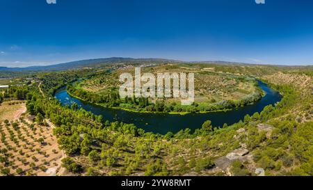 Aerial view of the Flix meander, where the Ebro river forms a huge meander around the castle and village of Flix (Tarragona, Catalonia, Spain) Stock Photo