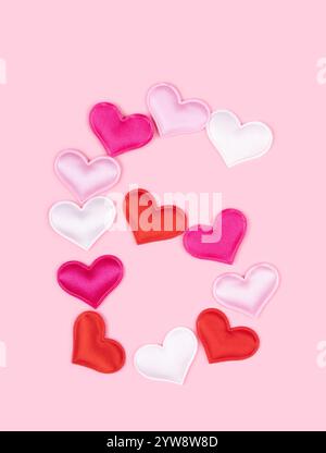 Number 6 six made of glossy atlas hearts isolated on solid pink background. Love alphabet concept. One letter of the set of heart's font easy to stack Stock Photo