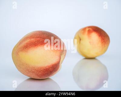 White Swan Peaches Isolated on White Background with Reflection. Stock Photo