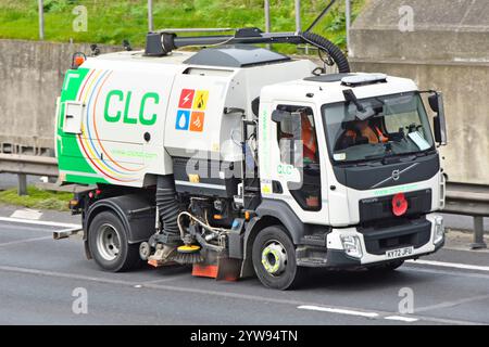 Front side view Volvo FL chassis cab fitted with road sweeper and drain gully suction equipment Remembrance Day Poppy on M25 Motorway road England UK Stock Photo
