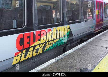 Celebrating Black History colourful red yellow green banner on Greater Anglia passenger train carriage an annual October event for 2024 seen Essex UK Stock Photo