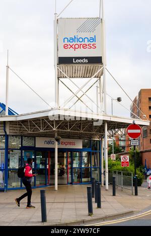 Leeds England: 3rd June 2024: A passenger walks towards the entrance of the National Express bus station in Leeds on a cloudy afternoon Stock Photo